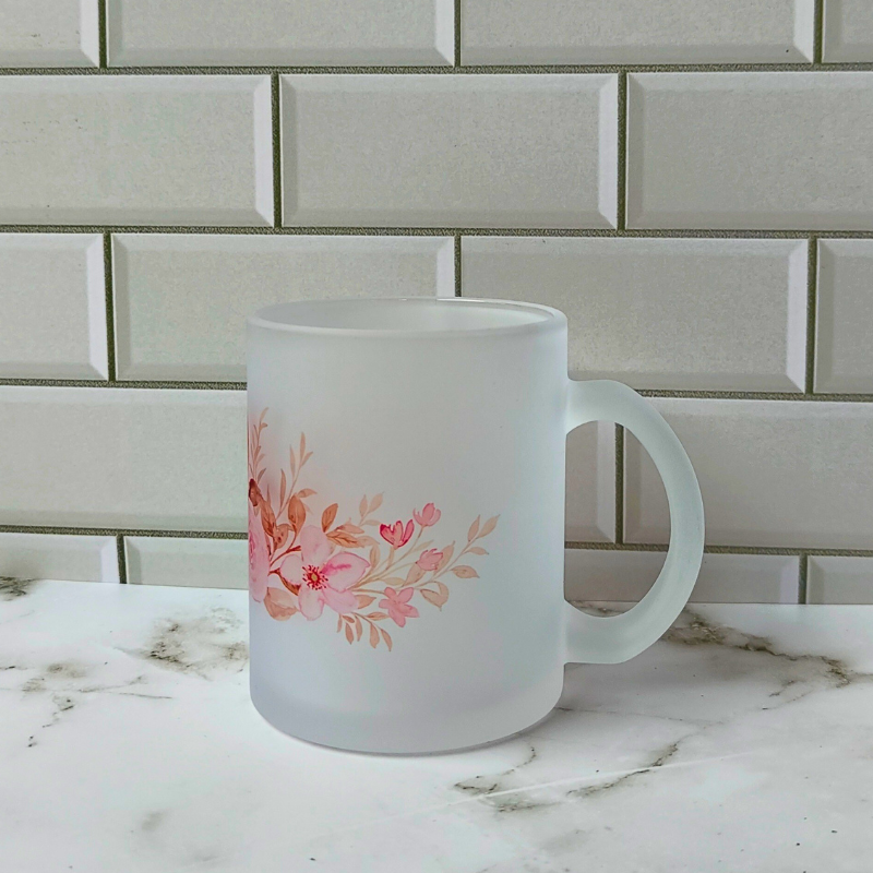 Frosted glass cup with pink flowers design.