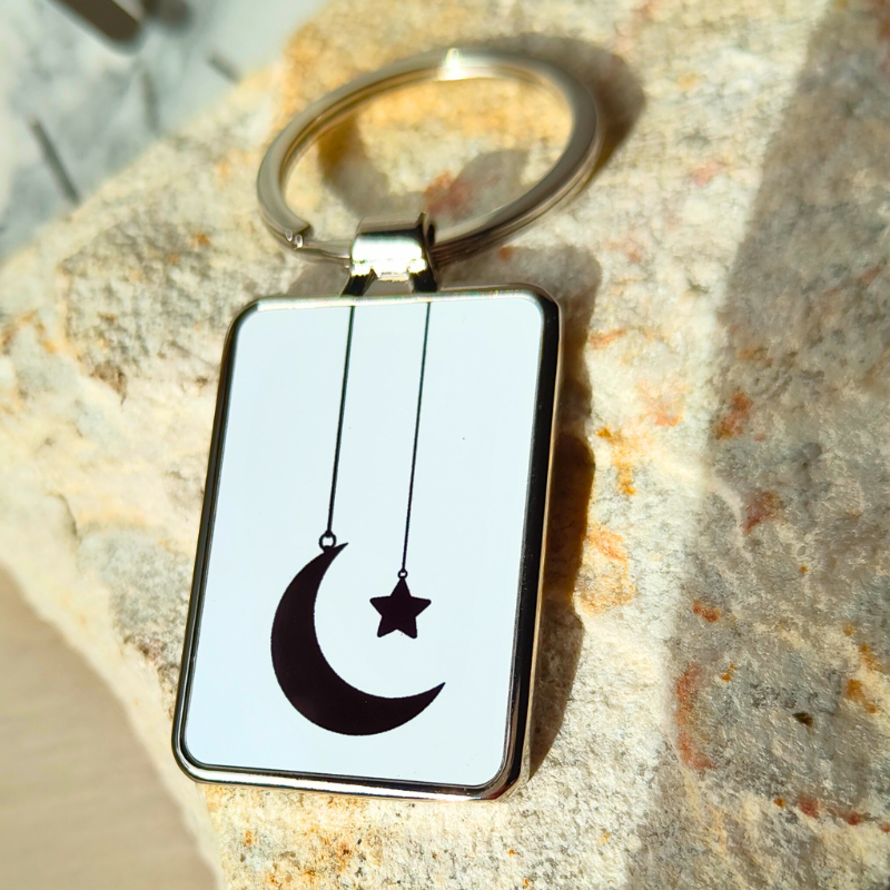 Silver finish metal keyring with subtle Islamic design - hanging moon and star in black and white.