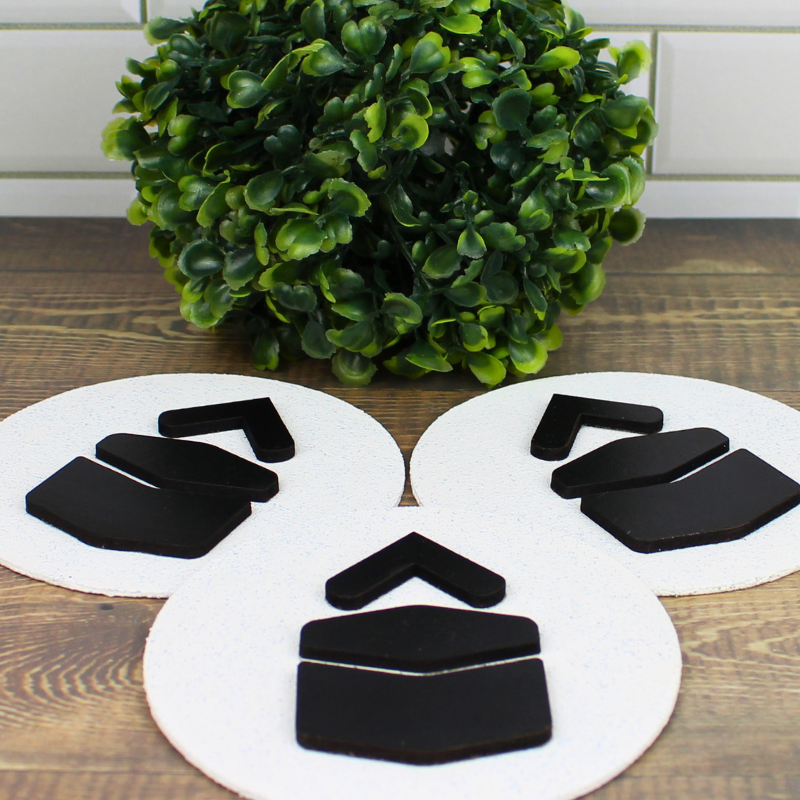 Qibla directional signs with plywood and stone finish, raised wooden arrows and Kaaba design.