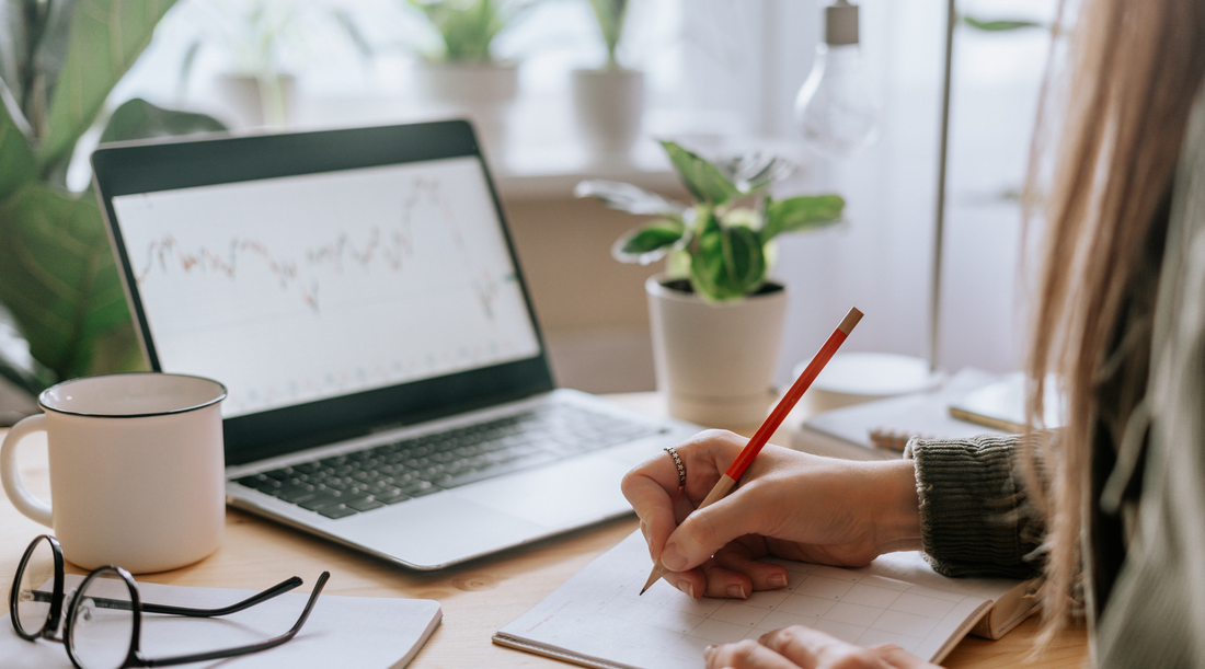 Woman writing in front of computer - Nest and Noor First Blog Post
