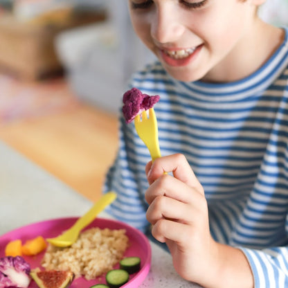 Free from melamine, and biodegradable and compostable, our plant-based spoon and fork cutlery set makes mealtimes (and sneaky snacks) way more fun! Yellow cutlery lifestyle image.