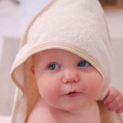 Wrap your baby in pure comfort with our Premium Hooded Baby Bath Towel. Lifestyle image on baby