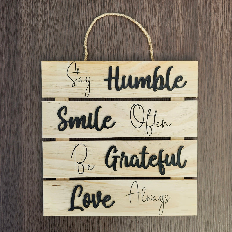 Wooden sign with motivational phrases on a wooden background