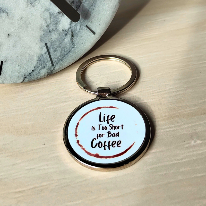 Round metal keyring with life is too short for bad coffee print.