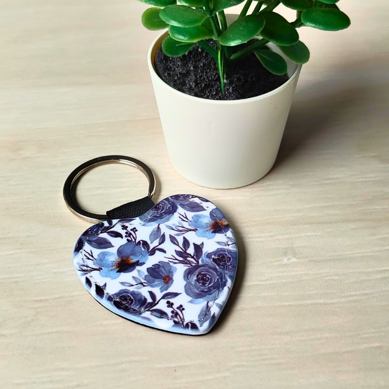 Blue floral patterned vegan leather heart shaped keyring.
