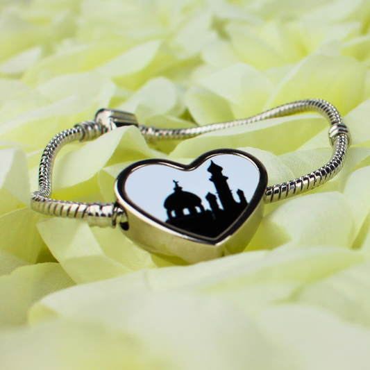 Silver charm bracelet with heart-shaped mosque charm.
