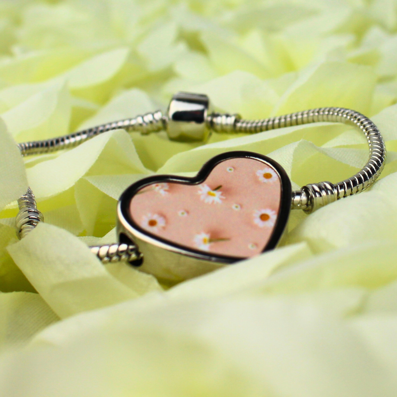 Daisy printed charm with silver charm bracelet.