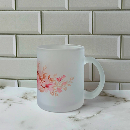Frosted glass cup with pink flowers design.