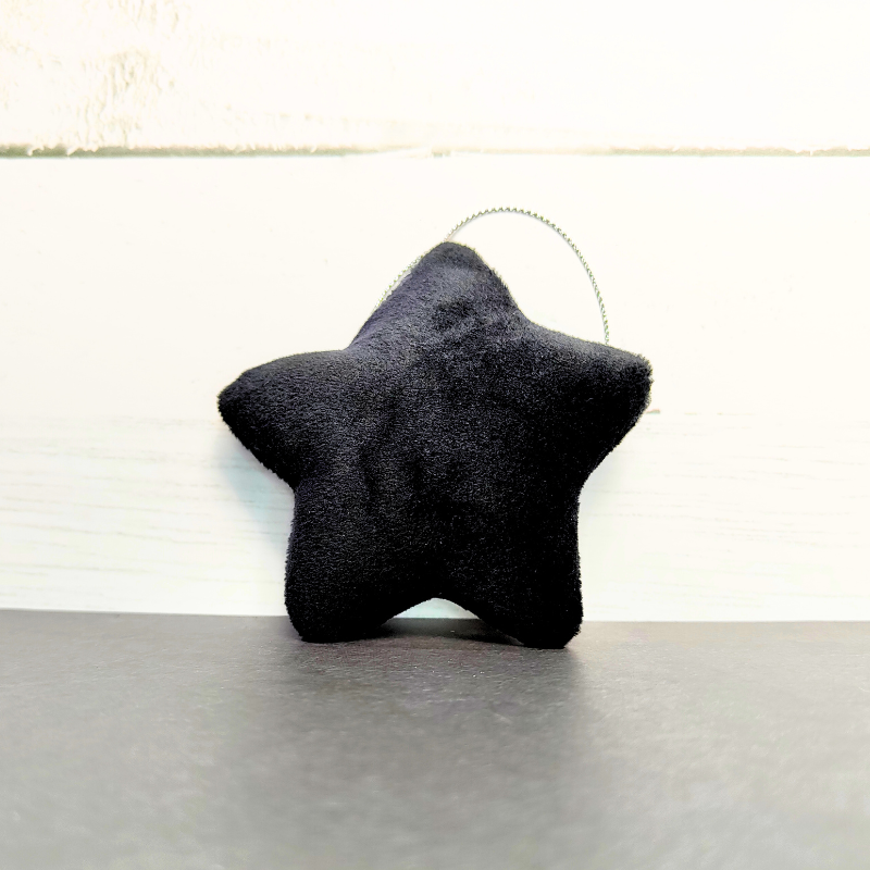 Hanging soft star with string in black.