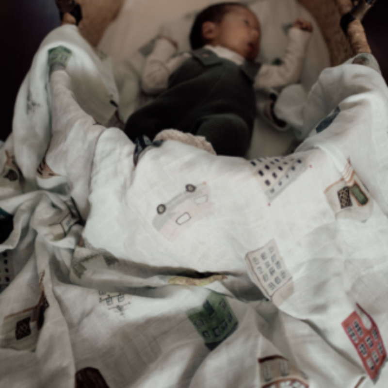 Discover our collection of gorgeous 100% organic cotton muslin swaddles that are lightweight, breathable, and machine washable. Ole house design lifestyle image with baby in moses basket