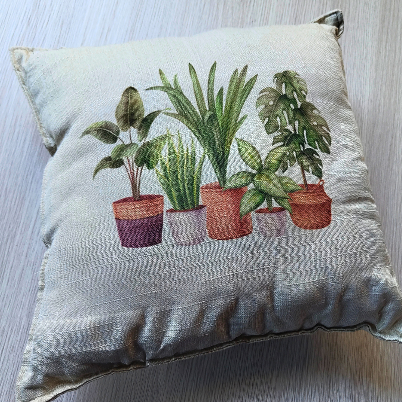 Cream coloured decorative statement cushion with houseplants print.