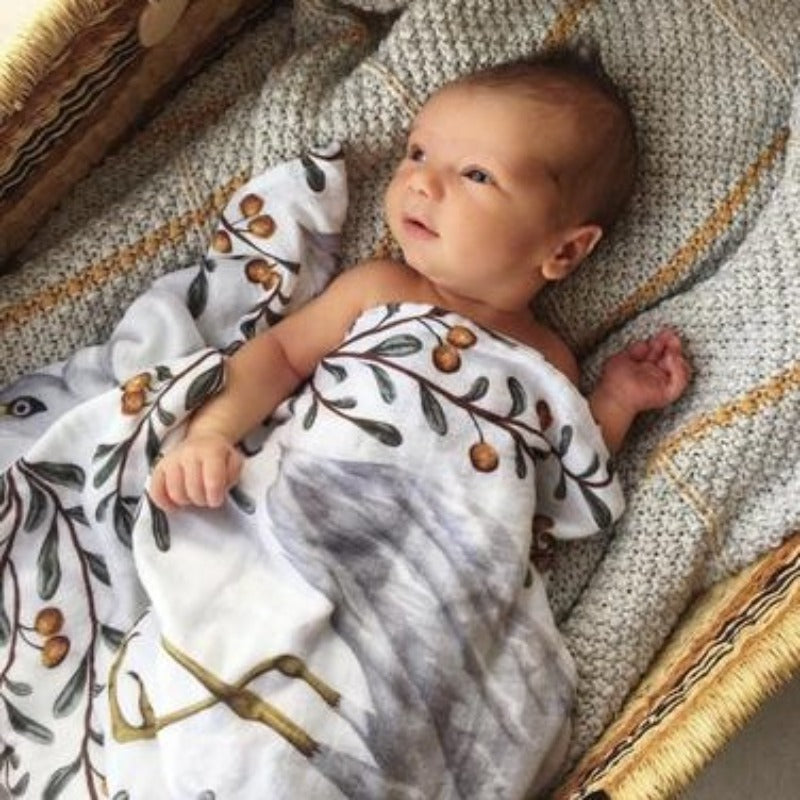 Discover our collection of gorgeous 100% organic cotton muslin swaddles that are lightweight, breathable, and machine washable. Baby wrapped in crane design swaddle.