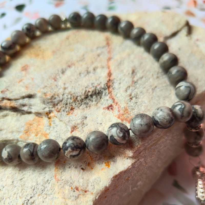 Grey stone-look Islamic prayer beads, 33 count with metal tassel.