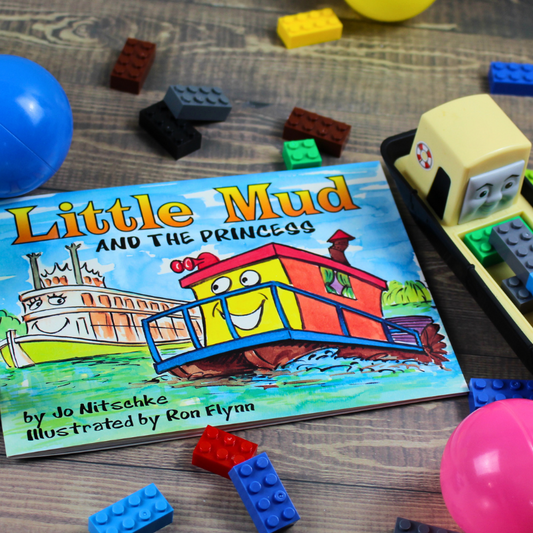 Little Mud and The Princess: An Australian Murray River Children's Book, flatlay image with boat, lego and balls