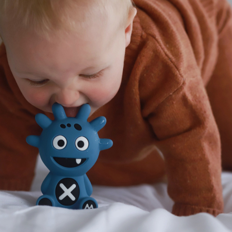Mibblers Silicone Teether - 100% Latex-Free, Safe, and Adorable Teething Toy. Child playing with Blue Mibbler.