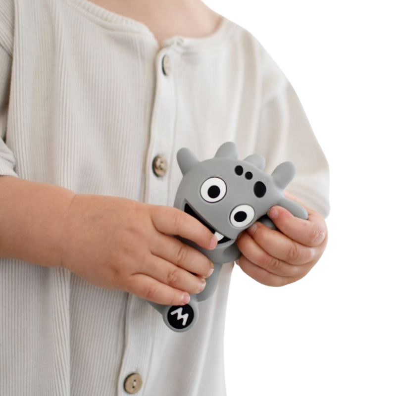 Mibblers Silicone Teether - 100% Latex-Free, Safe, and Adorable Teething Toy. Child playing with Grey Mibbler.