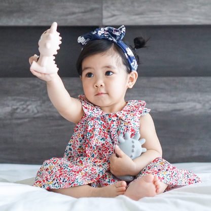 Mibblers Silicone Teether - 100% Latex-Free, Safe, and Adorable Teething Toy. Child playing with Mibblers.