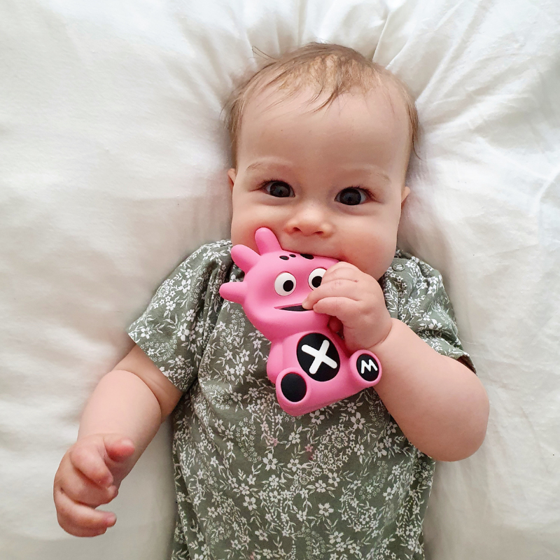 Mibblers Silicone Teether - 100% Latex-Free, Safe, and Adorable Teething Toy. Child playing with Pink Mibbler.
