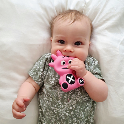 Mibblers Silicone Teether - 100% Latex-Free, Safe, and Adorable Teething Toy. Child playing with Pink Mibbler.