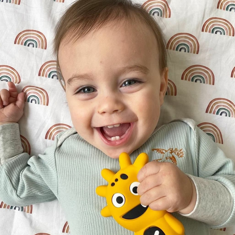 Mibblers Silicone Teether - 100% Latex-Free, Safe, and Adorable Teething Toy. Child playing with Yellow Mibbler.