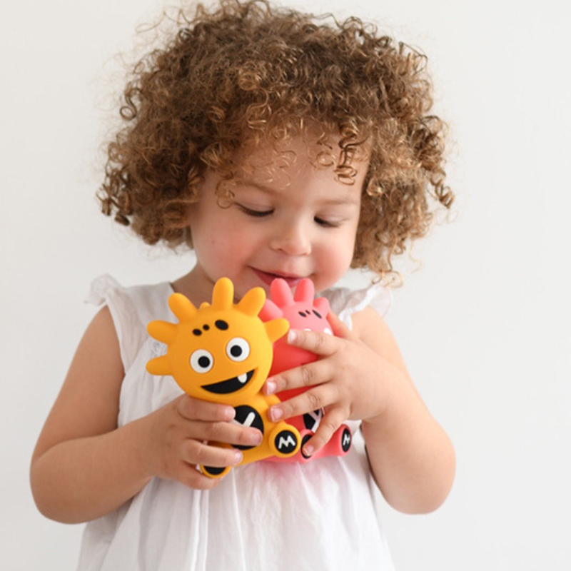 Mibblers Silicone Teether - 100% Latex-Free, Safe, and Adorable Teething Toy. Child playing with Mibblers.