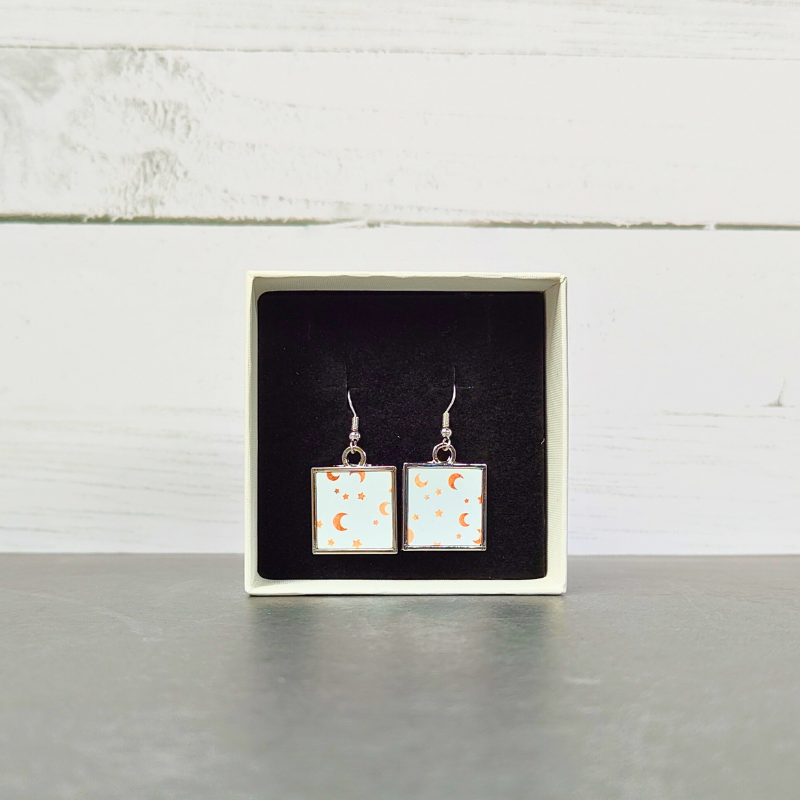 White/Gold moon and stars printed square stainless steel drop earrings front view