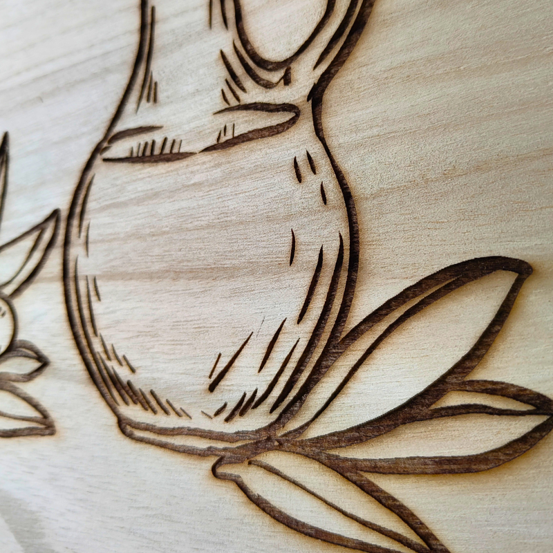 Round wooden decor piece with engraved olive oil design. Modern Islamic home decor made in Australia.