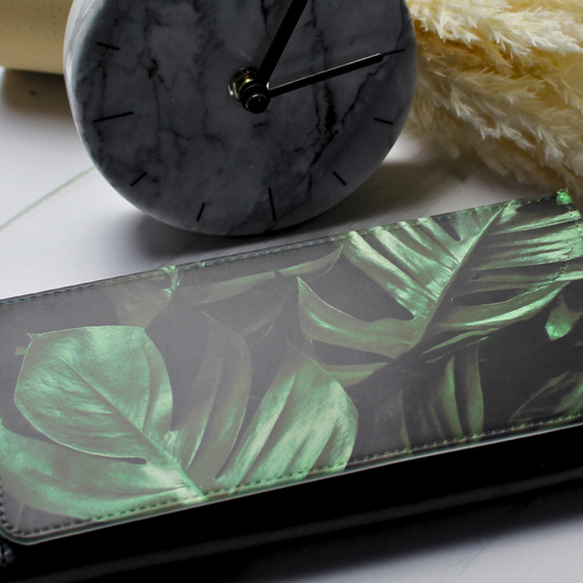 Vegan leather purse with monteserat palm leaves with clock and floral background