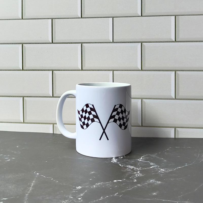 Ceramic coffee mug with checkered racing flags print.