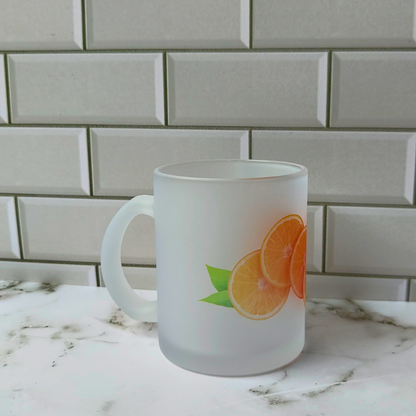 Frosted glass cup with whole sliced orange design.