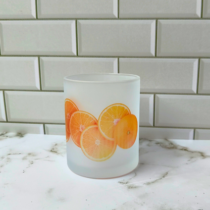 Frosted glass cup with sliced orange design.