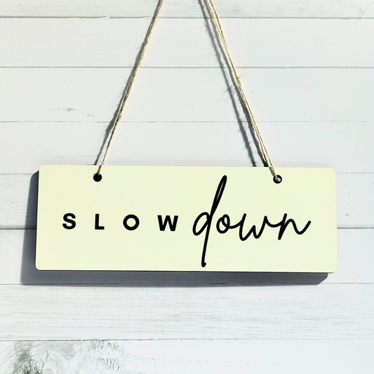 Hanging door sign with slow down reminder.