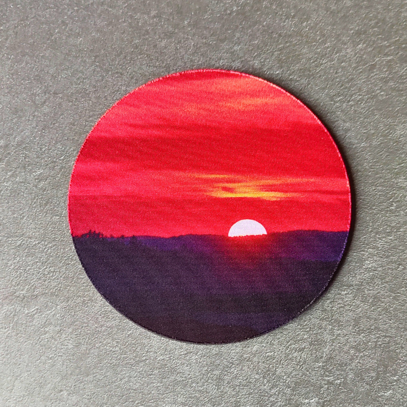 Non-slip sunset printed drink coaster.