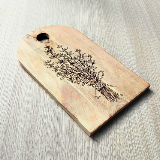 Wooden tag with engraved bundle of herbs on a light wooden surface