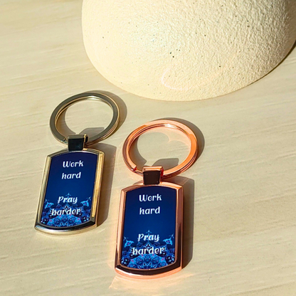 Blue printed metal keyrings in rose gold look or silver finish with work hard pray harder design.