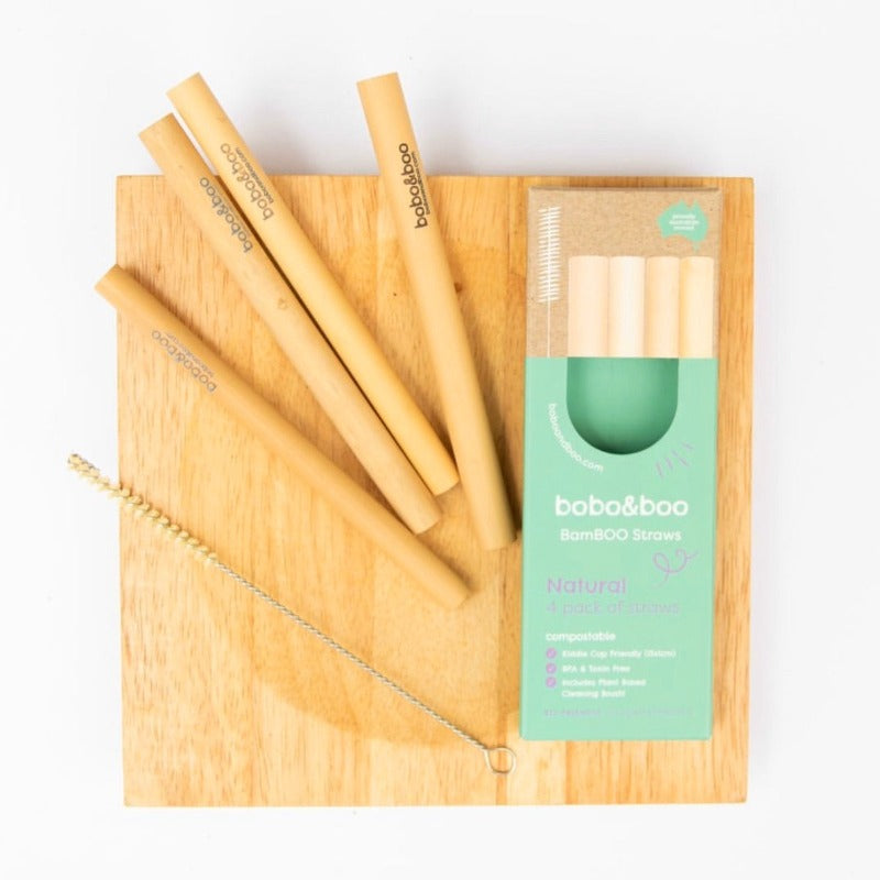 BamBOO Reusable Straws, 4 pack displayed with free straw cleaner next to packaging box, displayed on a wooden board.