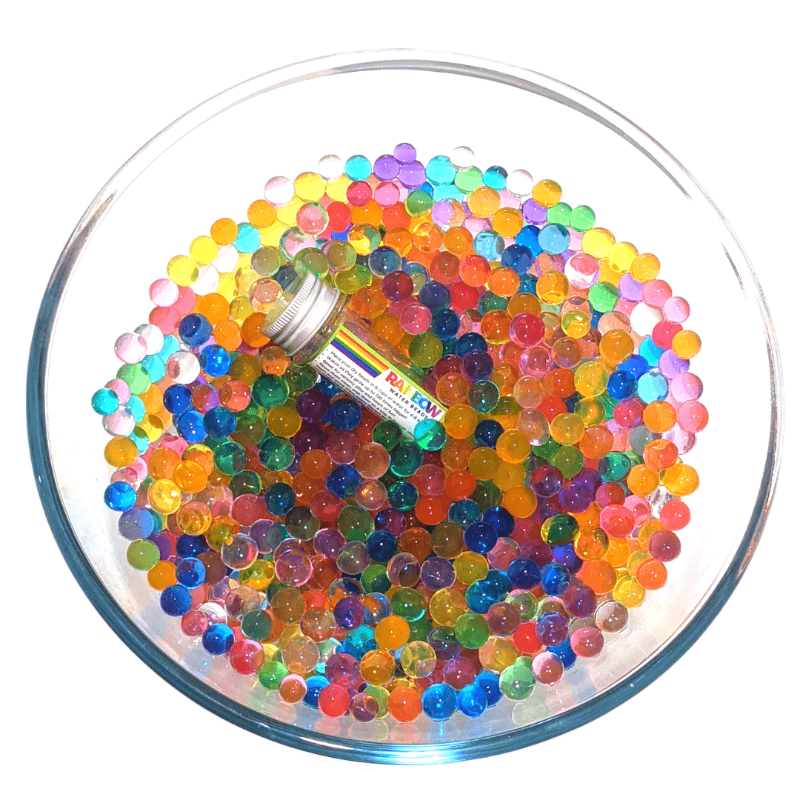 Discover our vibrant rainbow water beads! These reusable and certified water beads provide hours of sensory play. Non-toxic, biodegradable, and safe for kids above 5. Hydrated water beads in large glass bowl on white background.
