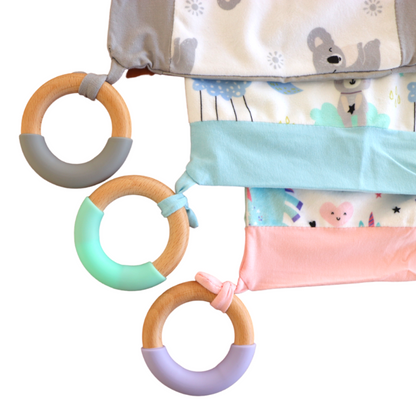 Introducing Cuddle Soother: The perfect blend of comfort and teething relief. Three designs and teethers laid flat on a plain white background.
