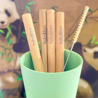 BamBOO Reusable Straws, 4 pack displayed with free straw cleaner inside of a green cup.
