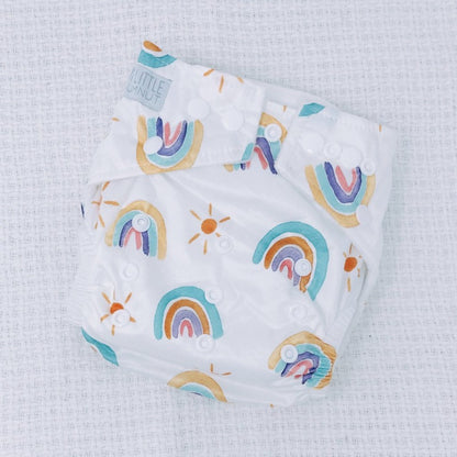 Switch to eco-friendly Modern Cloth Nappies (MCNs) for babies. Pastel rainbow design.